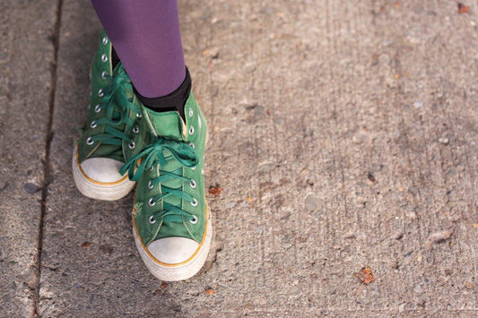 unique photo of purple legs wearing green shoes